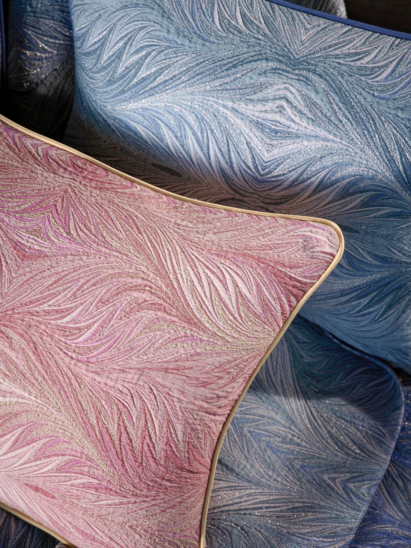 Close-up of textured pink and blue pillow covers with a swirling, marbled pattern and subtle glitter accents, featuring Boheme Pillow Cover by Celso de Lemos available at Linen Society.