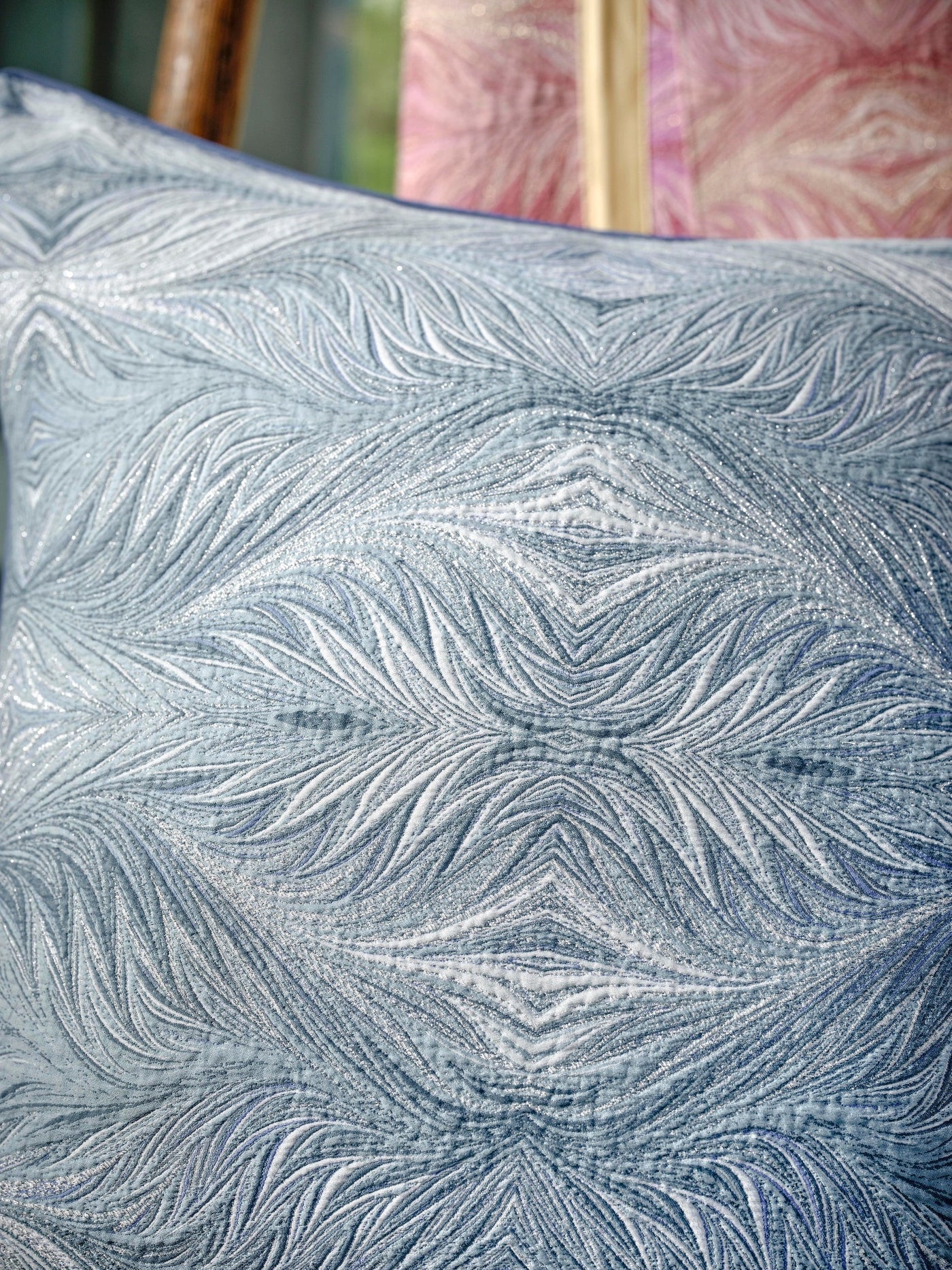 Close-up of a textured blue pillow cover with a subtle shimmer, featuring the Boheme Pillow Cover by Celso de Lemos available at Linen Society.