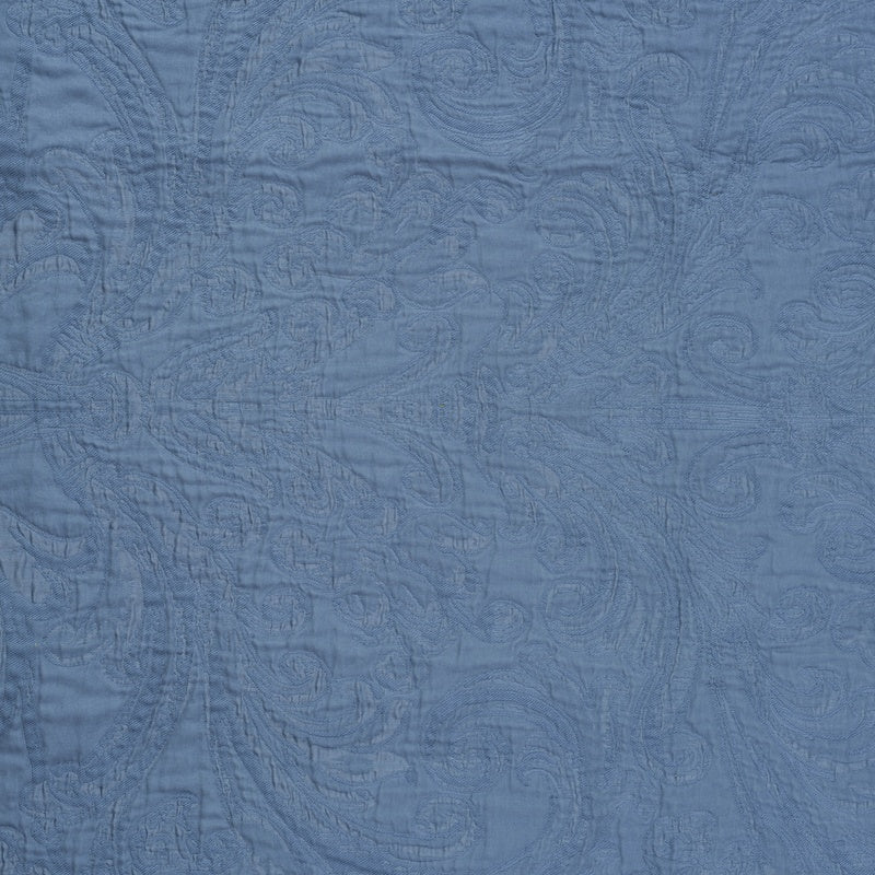 A blue fabric with a textured paisley pattern, featuring the Braga Pillow Cover by Celso de Lemos available at Linen Society.