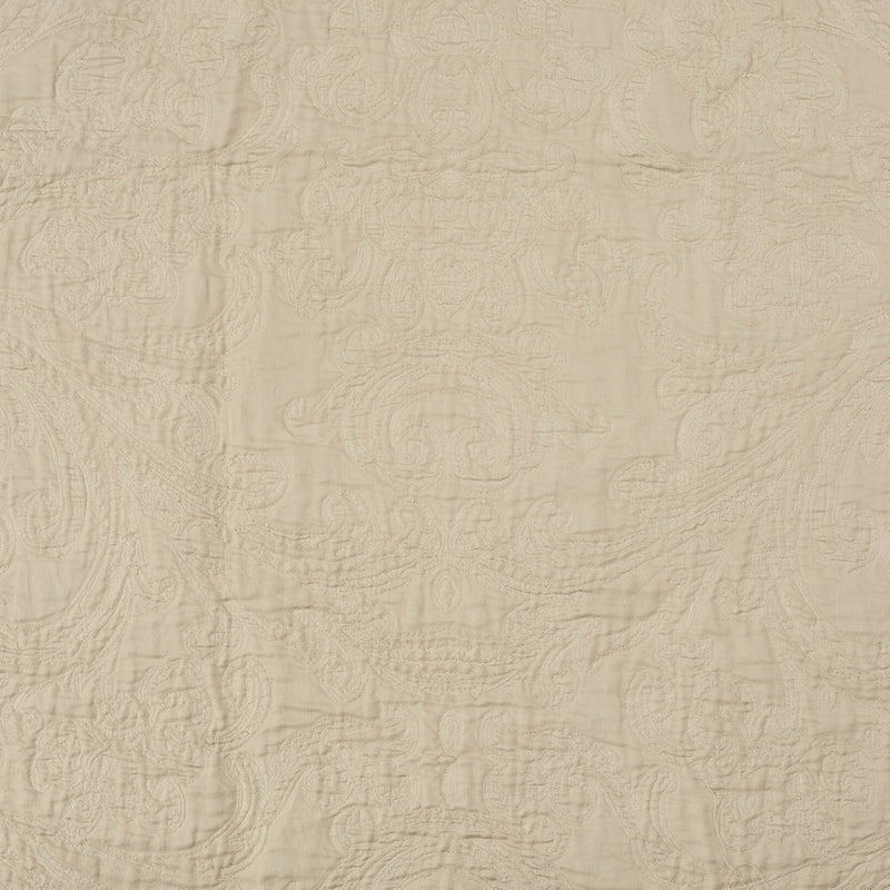 Close-up view of a cream-colored textile with an embossed paisley pattern, featuring Braga Pillow Cover by Celso de Lemos available at Linen Society.