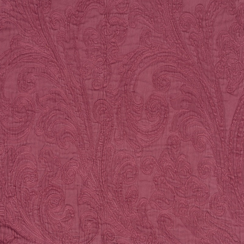 A close-up of a dark pink textile featuring an embroidered paisley pattern. featuring Braga Pillow Cover by Celso de Lemos available at Linen Society.