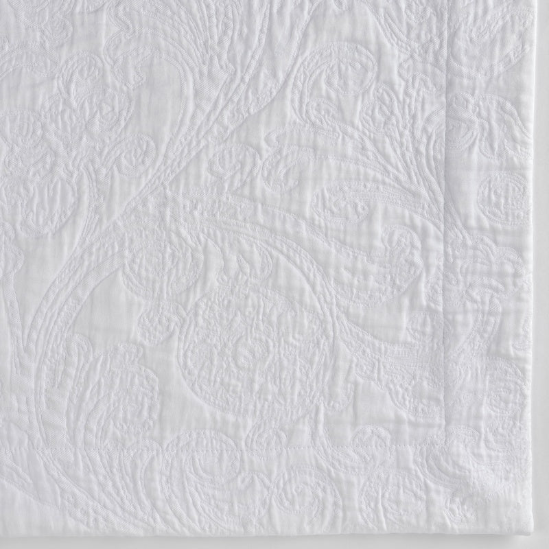 Close-up of white textured fabric with a raised damask pattern, featuring Braga Pillow Cover by Celso de Lemos available at Linen Society.