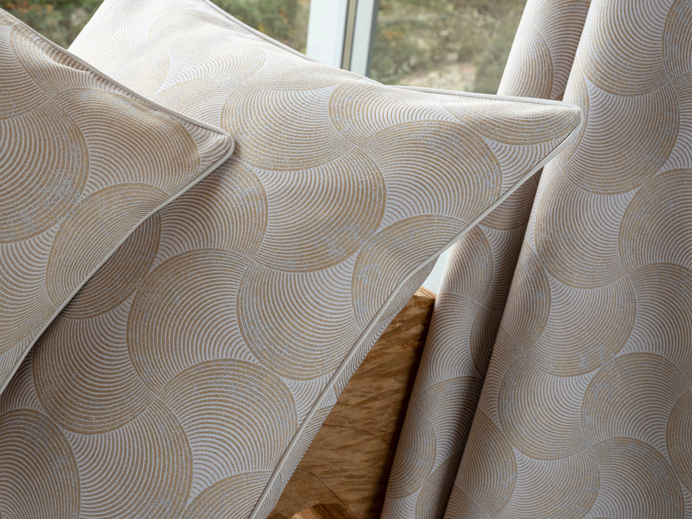 Close-up of beige and white patterned pillows and draped fabric, featuring Caviar Pillow Cover by Celso de Lemos available at Linen Society.