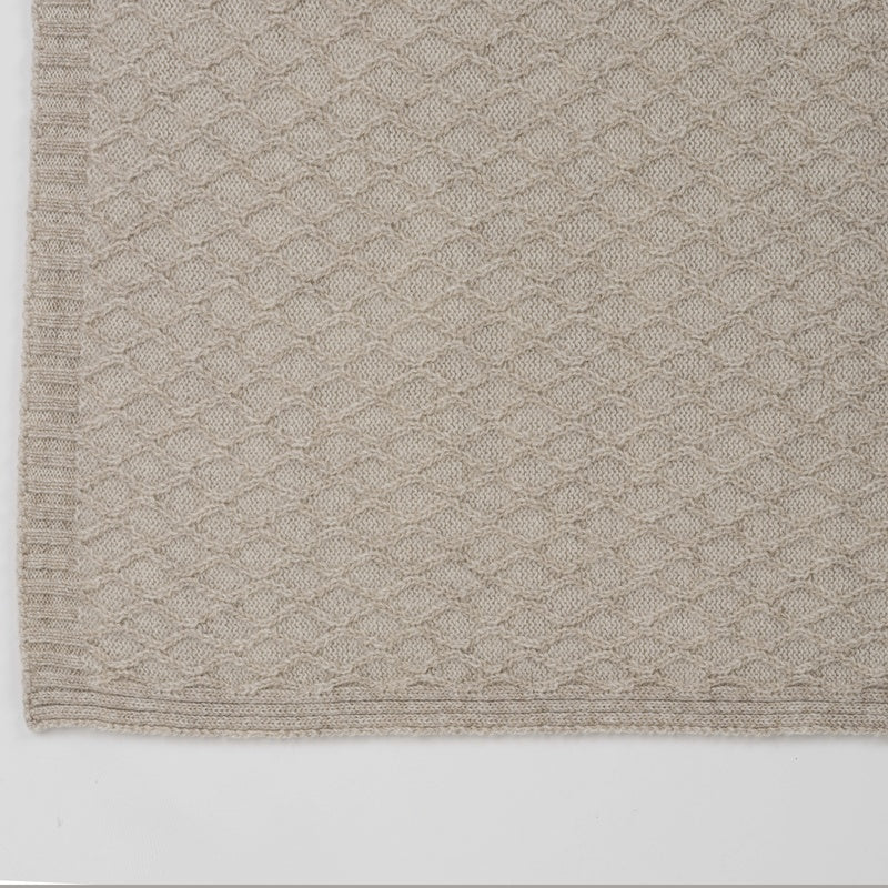 Close-up of Celso de Lemos Cécile throw corner in taupe with scalloped knit texture.
