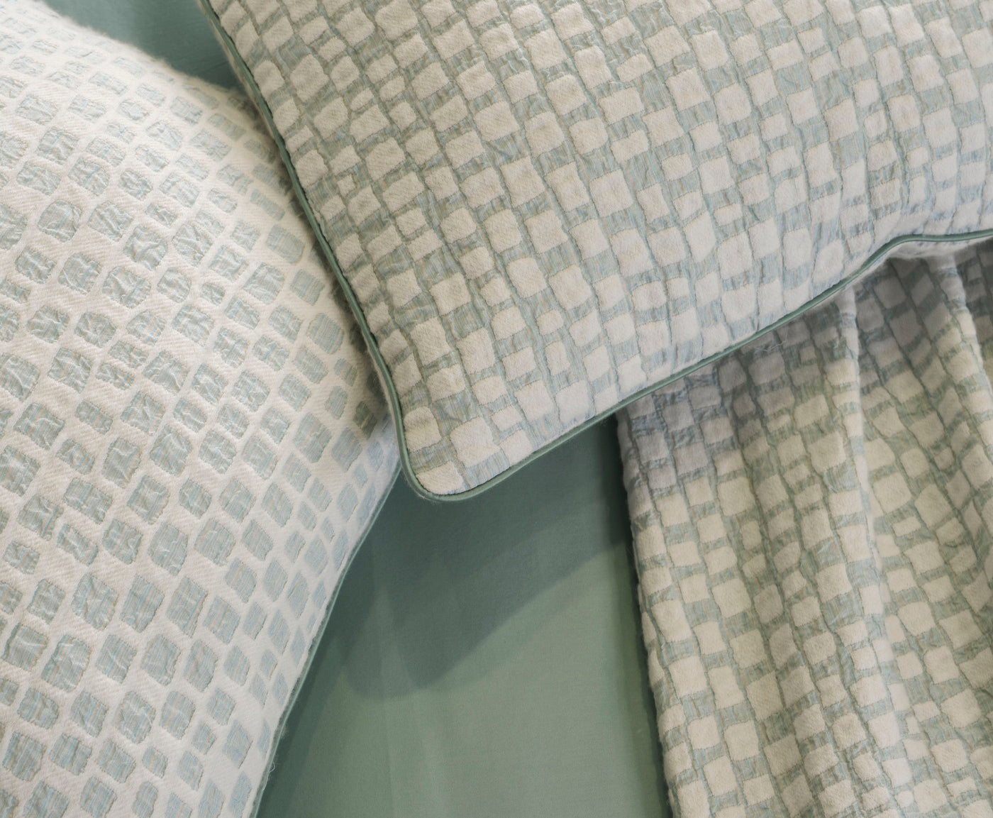 Close-up of light blue and white textured pillow covers, featuring City Pillow Cover by Celso de Lemos available at Linen Society.
