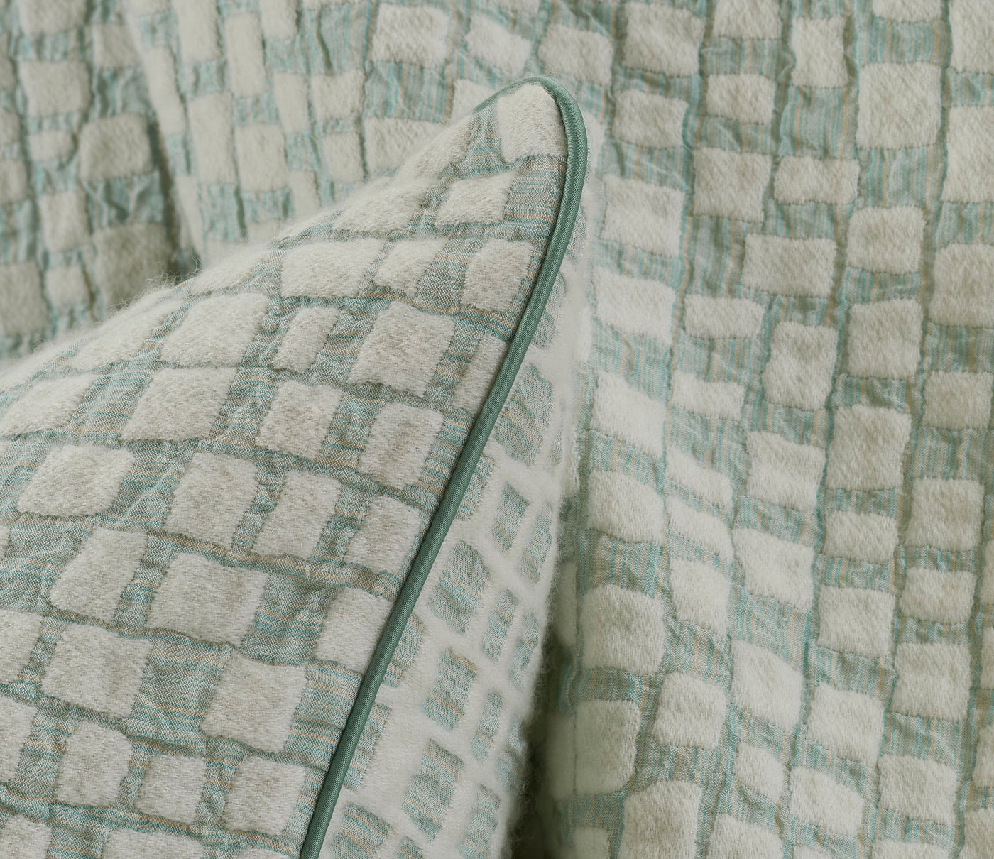 A textured, pale aqua and cream checkered pillowcase is shown. featuring City Pillow Cover by Celso de Lemos available at Linen Society.