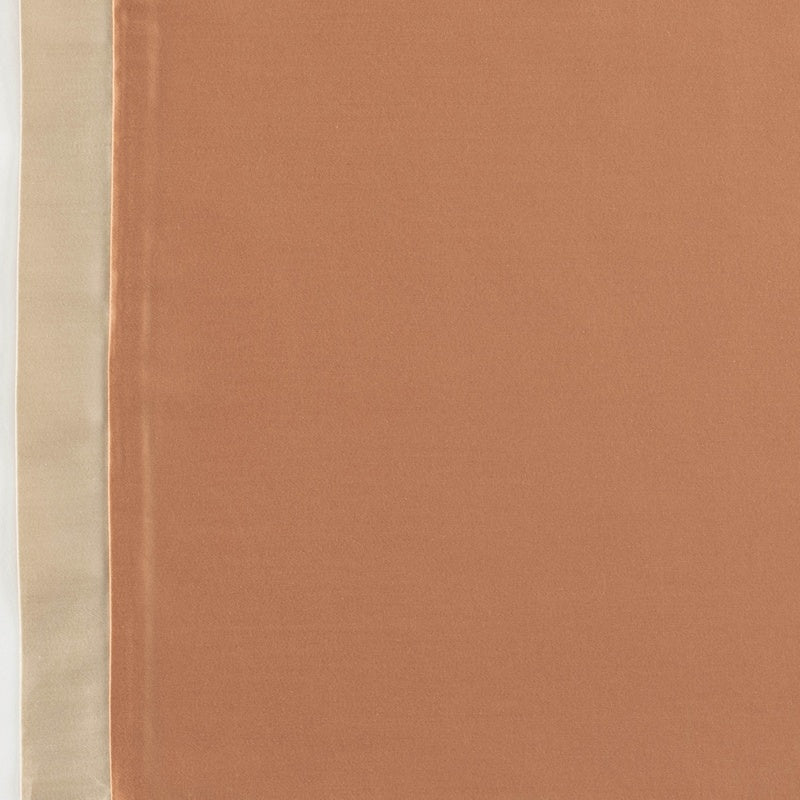 Close-up of a rust-colored fabric juxtaposed with a pale beige satin border, featuring Emma Pillowcase by Celso de Lemos available at Linen Society.