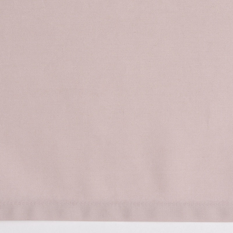 A close-up of a pale pink fabric with a subtle texture, featuring Estrela Pillowcase by Celso de Lemos available at Linen Society.