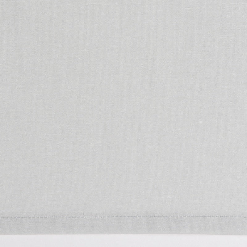 A soft gray textile with a subtle woven texture, showcasing a neatly stitched hemline, featuring Estrela Pillowcase by Celso de Lemos available at Linen Society.