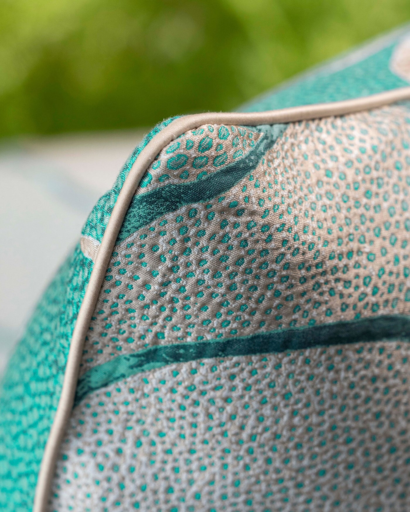 Close-up of a textured turquoise and cream pillow cover with piping, featuring Funchal Pillow Cover by Celso de Lemos available at Linen Society.
