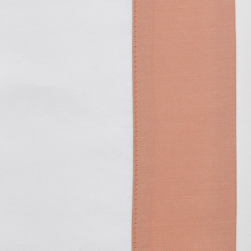 Close-up of a white fabric panel next to a textured rose-colored panel, featuring Hella Pillowcase by Celso de Lemos available at Linen Society.