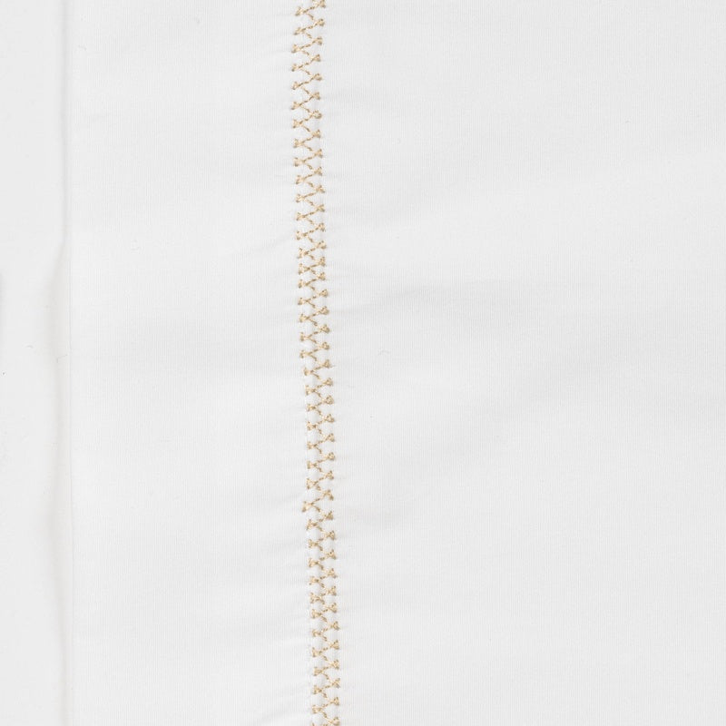 Close-up view of a white Pillowcase with delicate beige embroidery down one side, featuring the Ivy Pillowcase by Celso de Lemos available at Linen Society.