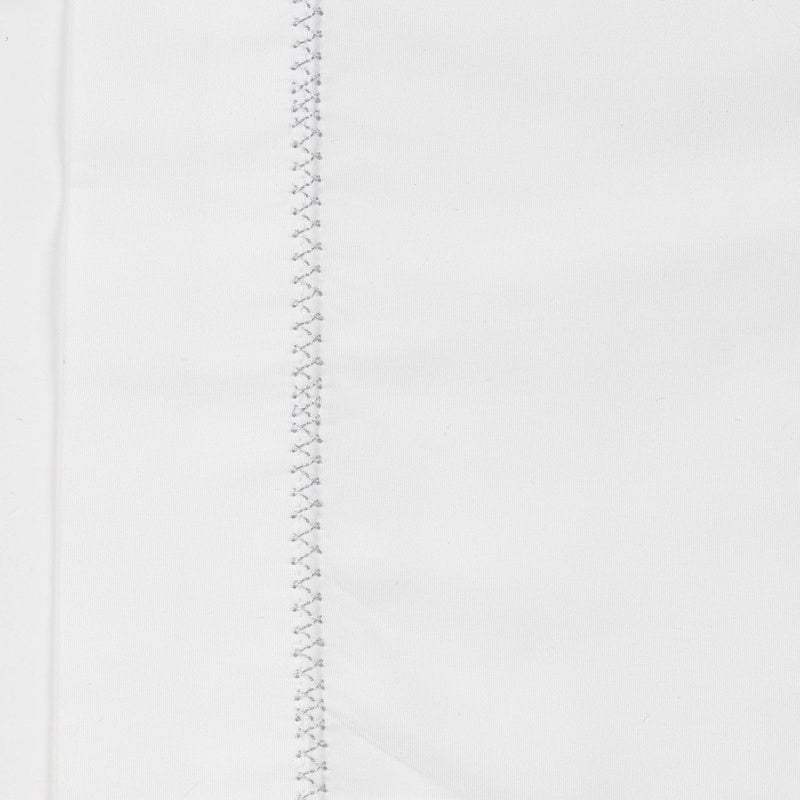 Close-up of a white pillowcase with a decorative stitch detail down one side, featuring Ivy Pillowcase by Celso de Lemos available at Linen Society.