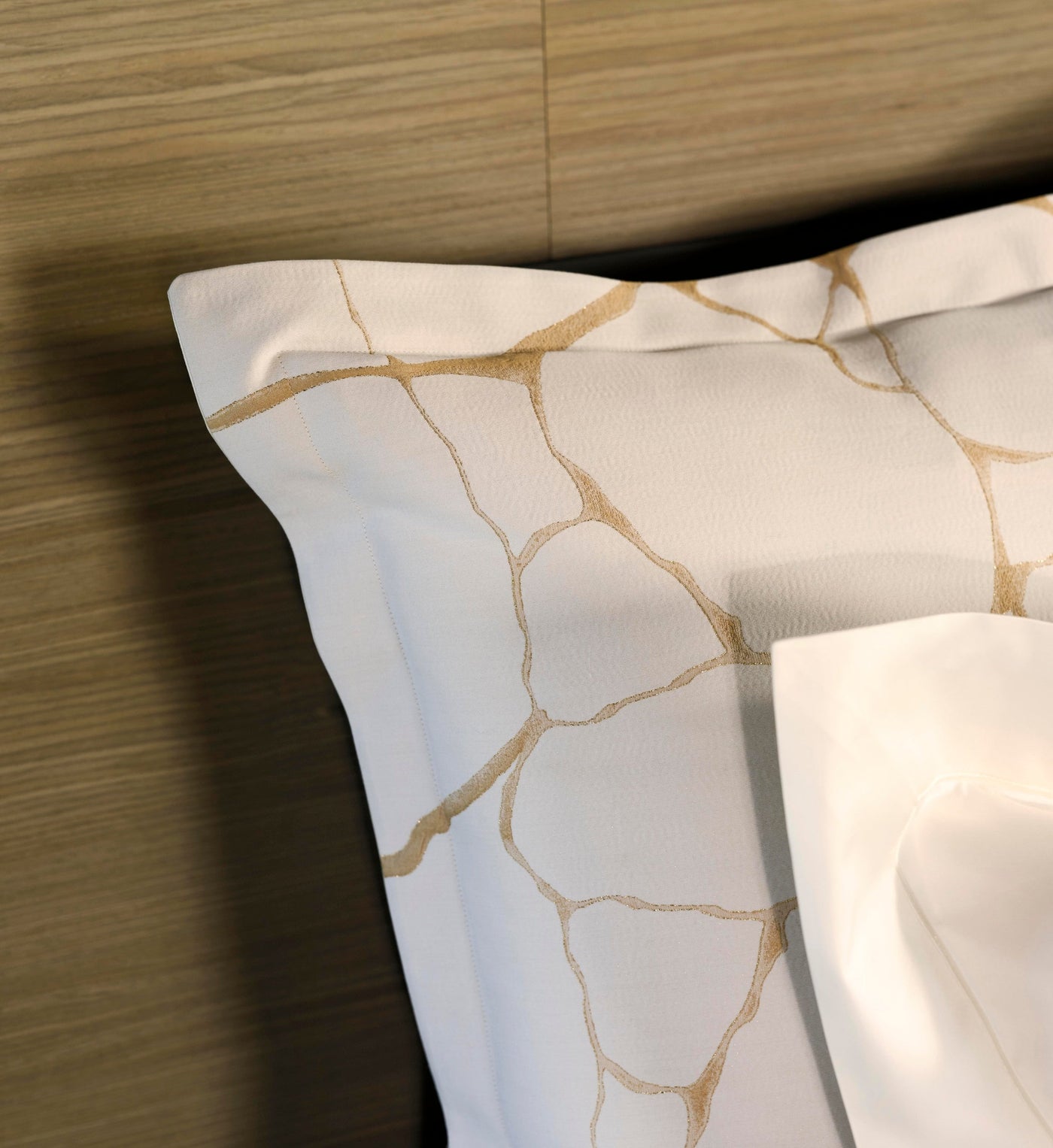 Close-up of a white Pillowcase with gold crackle pattern detail, featuring Jessie Pillowcase by Celso de Lemos available at Linen Society.