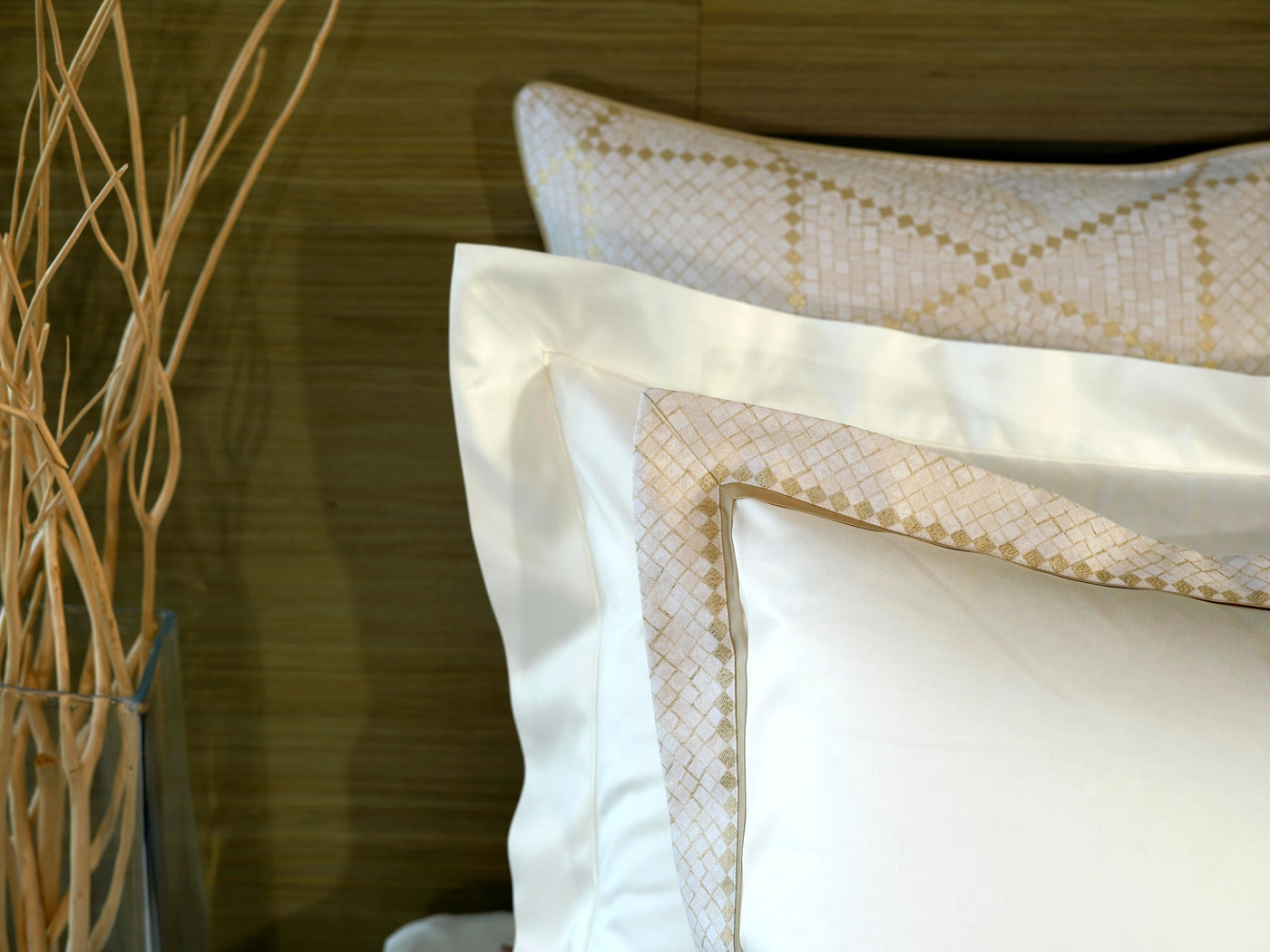 Close-up of white pillowcases with a textured gold trim. featuring Kerylos Pillowcase by Celso de Lemos available at Linen Society.