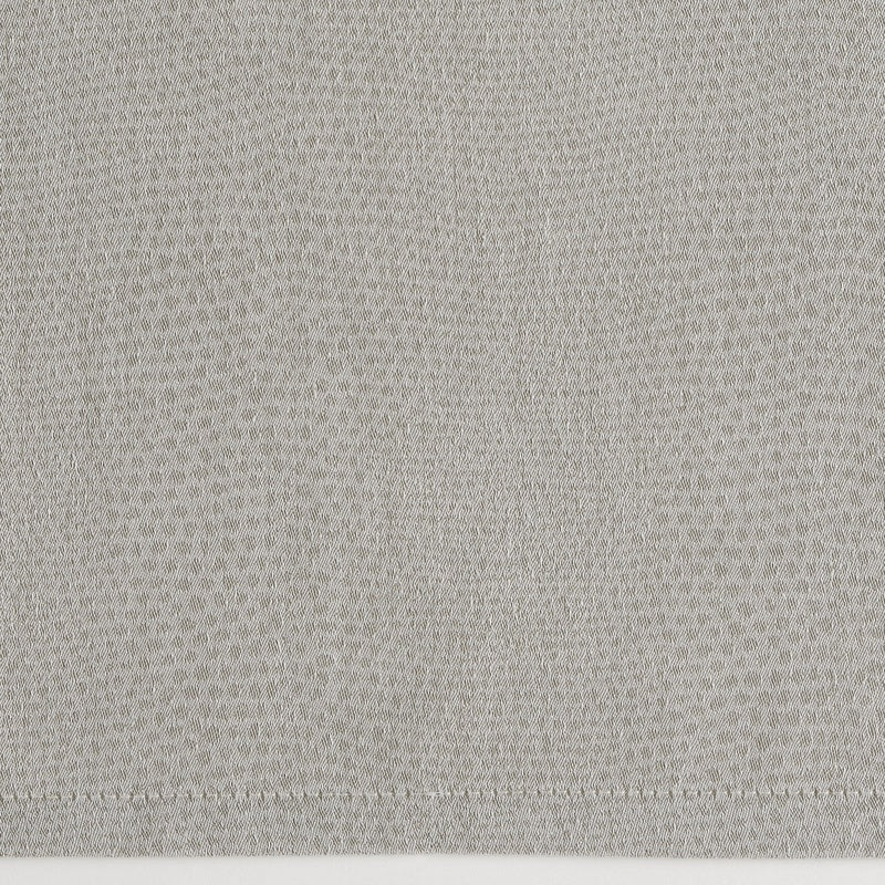 A close-up of light grey textured fabric with a subtle diamond pattern and a stitched hem, featuring Kroco Pillowcase by Celso de Lemos available at Linen Society.