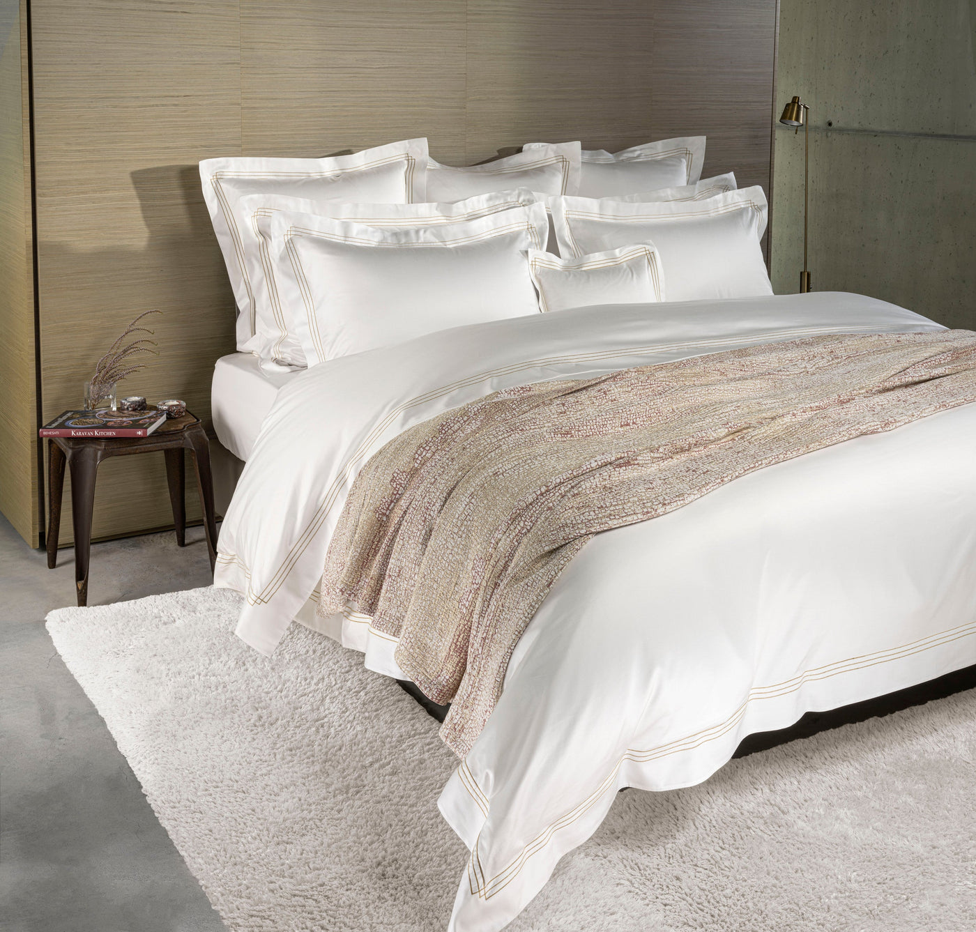 A neatly made bed with crisp white bedding and a textured throw, featuring Lems Pillow Cover by Celso de Lemos available at Linen Society.