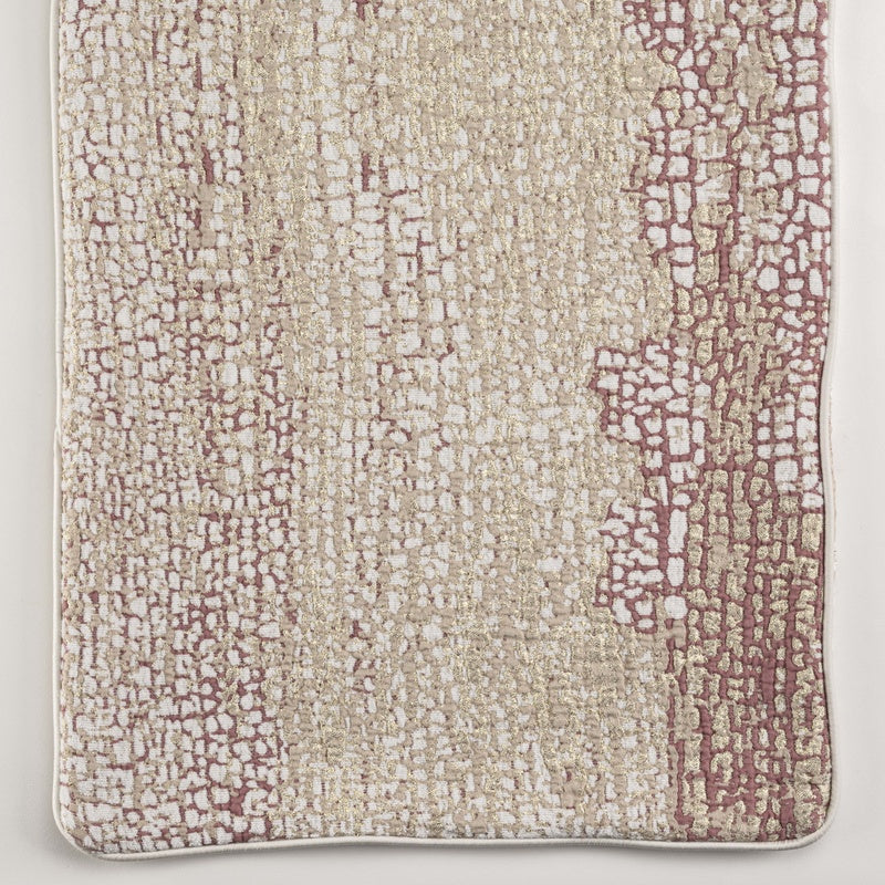 Close-up of a textured pillow cover with a mosaic-like pattern in dusty rose and gold, featuring Lems Pillow Cover by Celso de Lemos available at Linen Society.