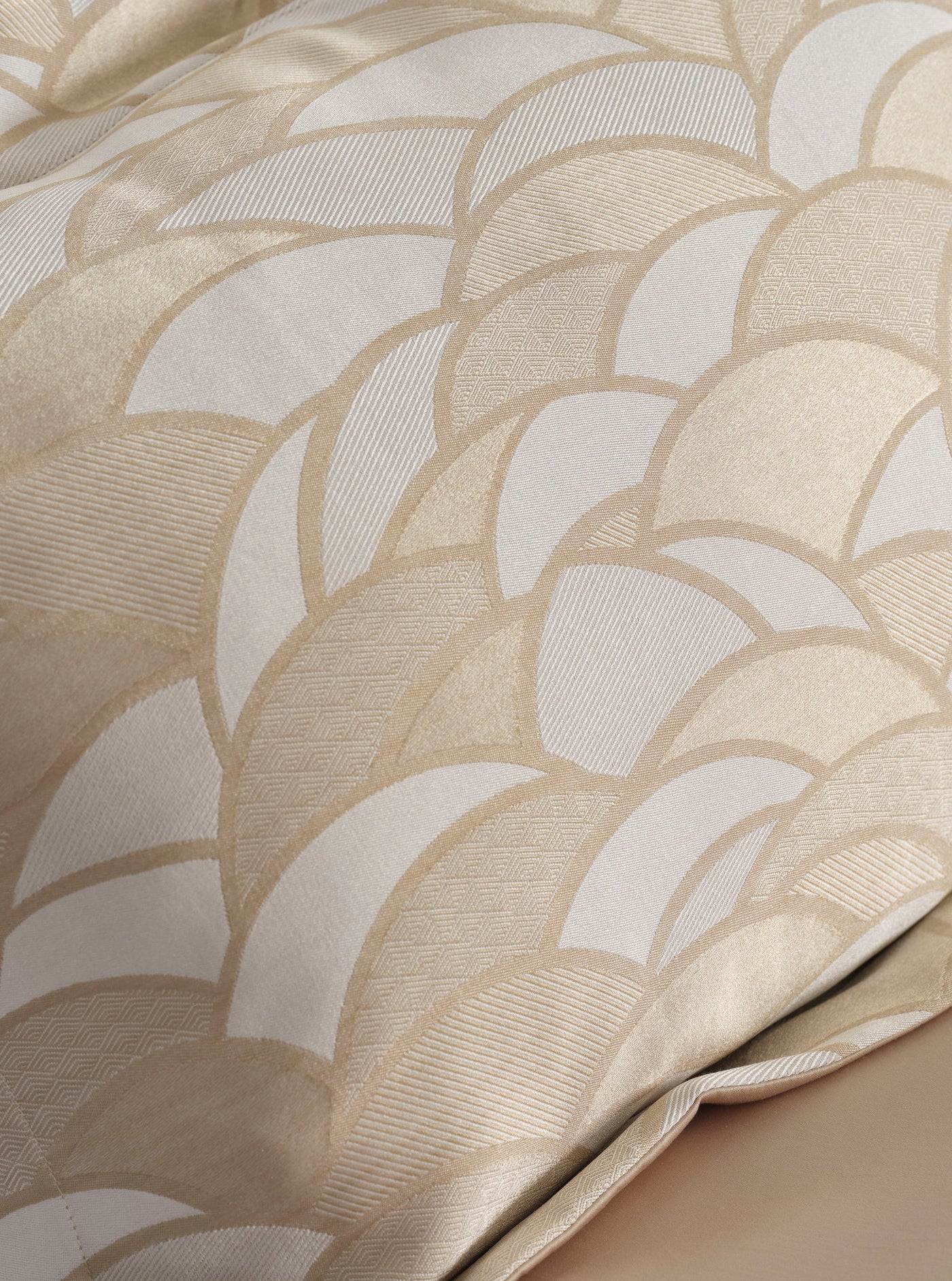 Close-up view of a textured fabric with a fan-like pattern in cream and beige, featuring Loulou Duvet Cover by Celso de Lemos available at Linen Society.