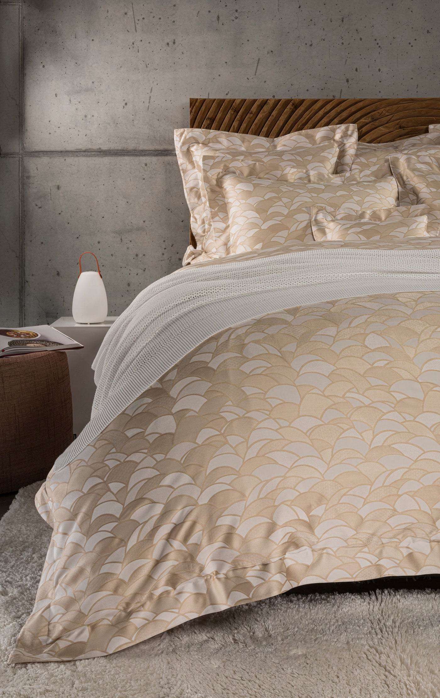 A modern bedroom setting with a tan and white patterned Pillowcase, featuring Loulou Pillowcase by Celso de Lemos available at Linen Society.