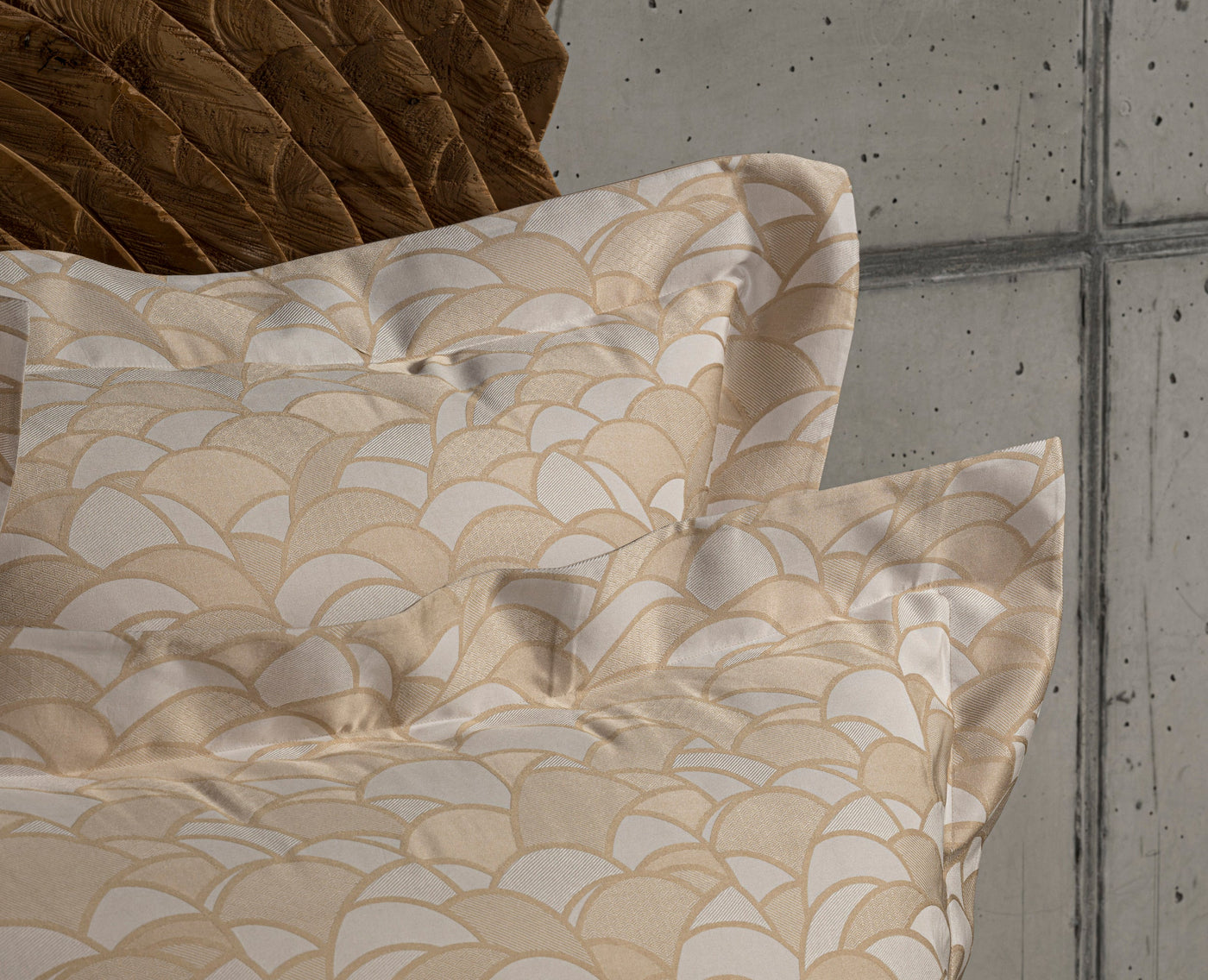 Close-up of folded beige and gold fan-patterned fabric, featuring Loulou Pillowcase by Celso de Lemos available at Linen Society.