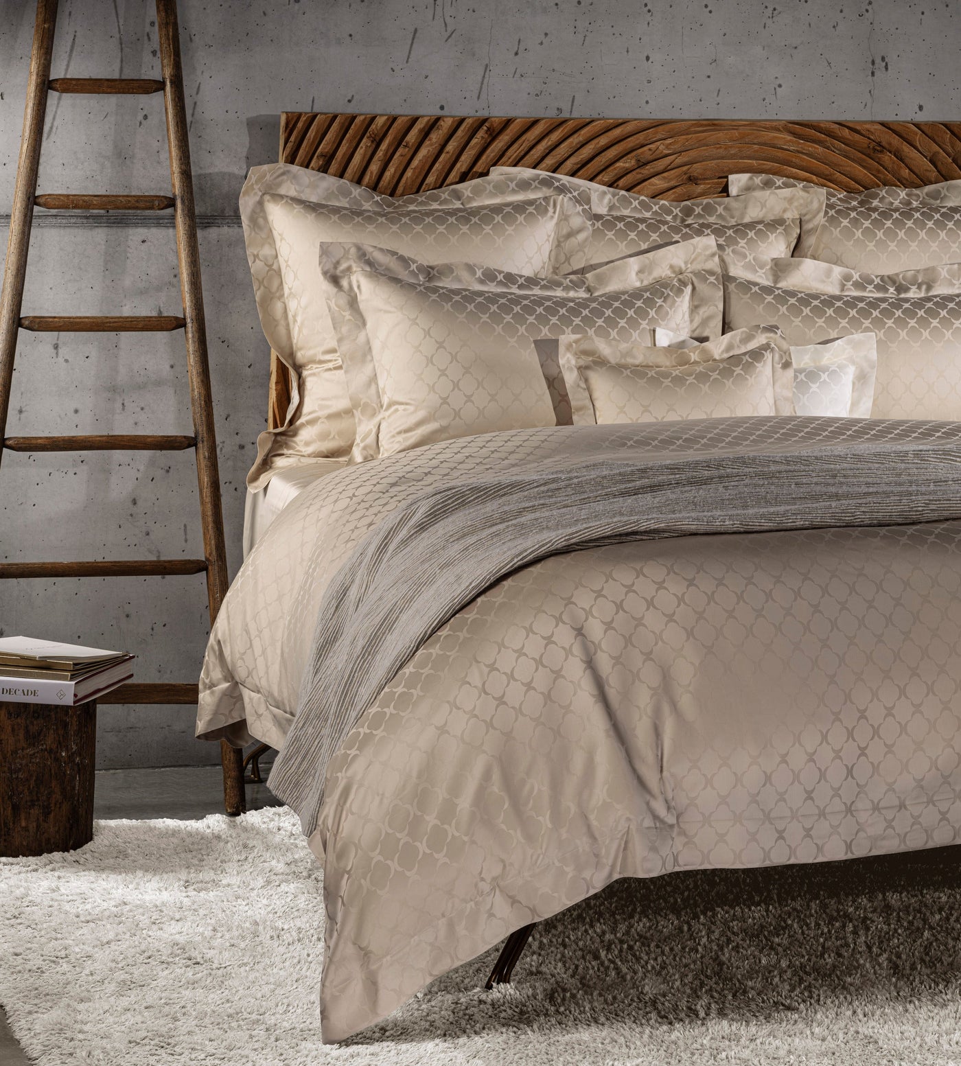 A bed styled with cream bedding featuring a subtle quatrefoil pattern. featuring Lua Pillowcase by Celso de Lemos available at Linen Society.
