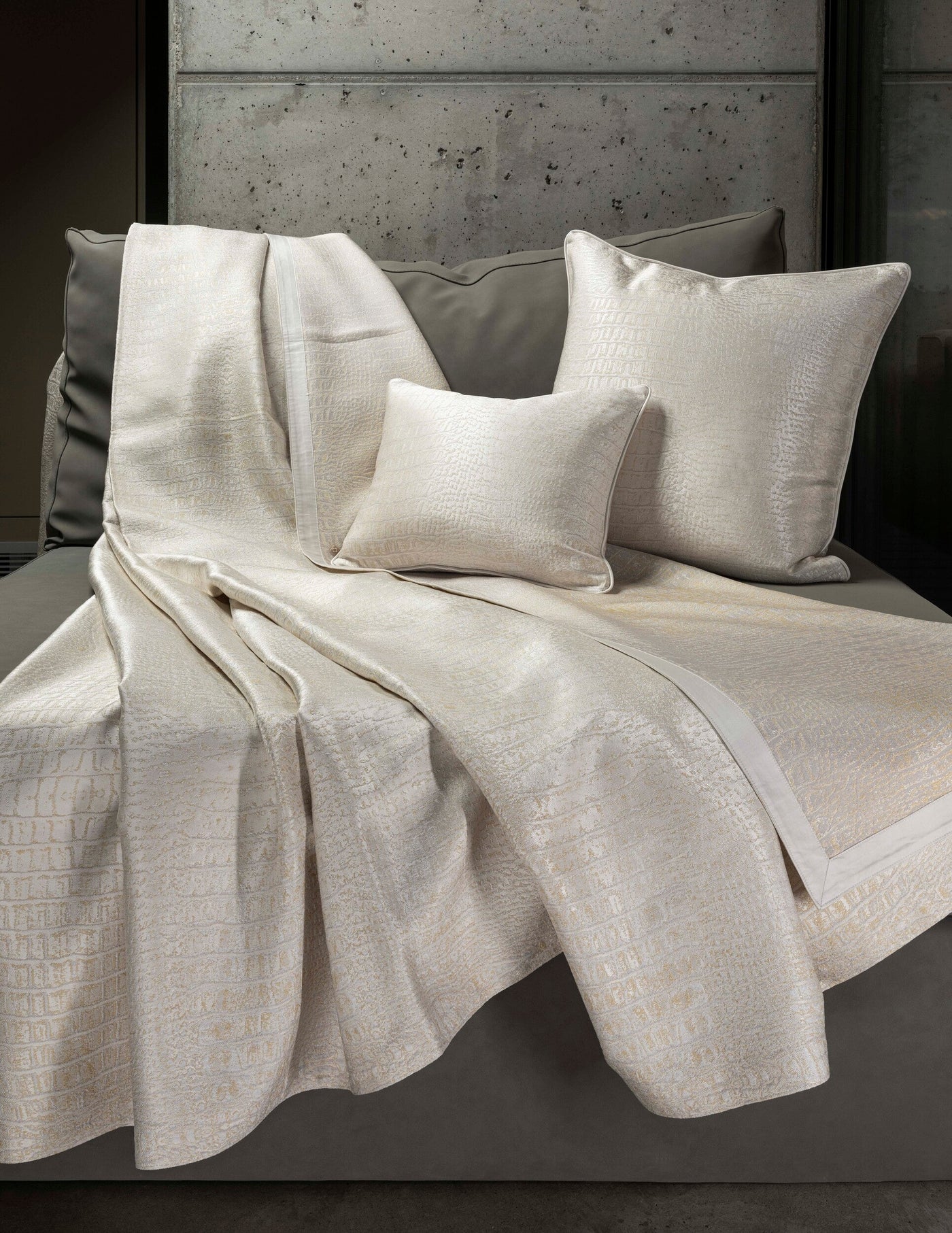Cream-colored textured Pillow Covers are draped on a bed. featuring Luxe Pillow Cover by Celso de Lemos available at Linen Society.