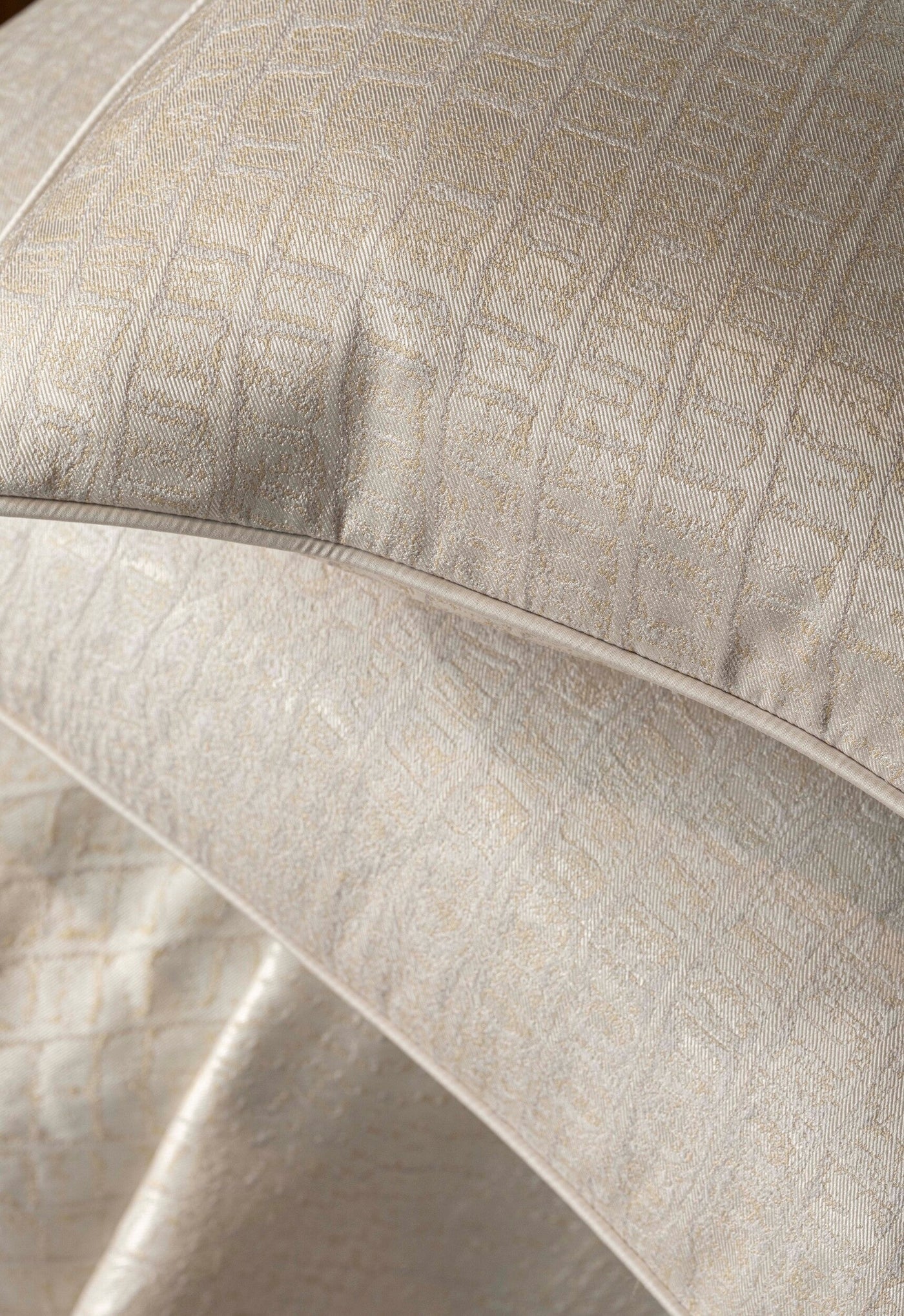 Close-up of a textured beige pillow cover with a subtle pattern, featuring Luxe Pillow Cover by Celso de Lemos available at Linen Society.