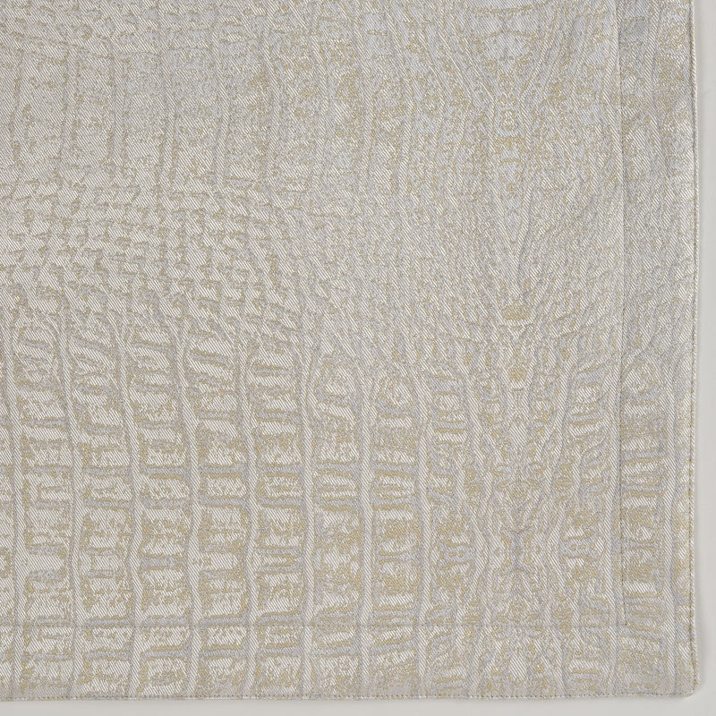 Close-up view of a textured, cream-colored fabric with an embossed pattern, featuring Luxe Pillow Cover by Celso de Lemos available at Linen Society.