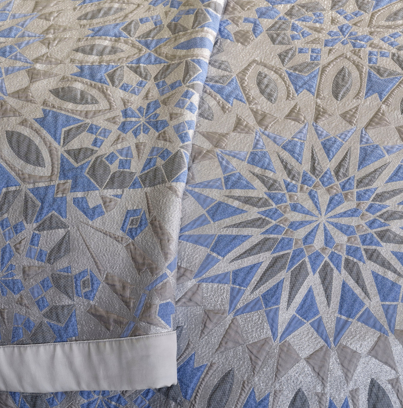 A geometric pattern in blue, grey, and silver with a textured finish, featuring Milena Pillow Cover by Celso de Lemos available at Linen Society.