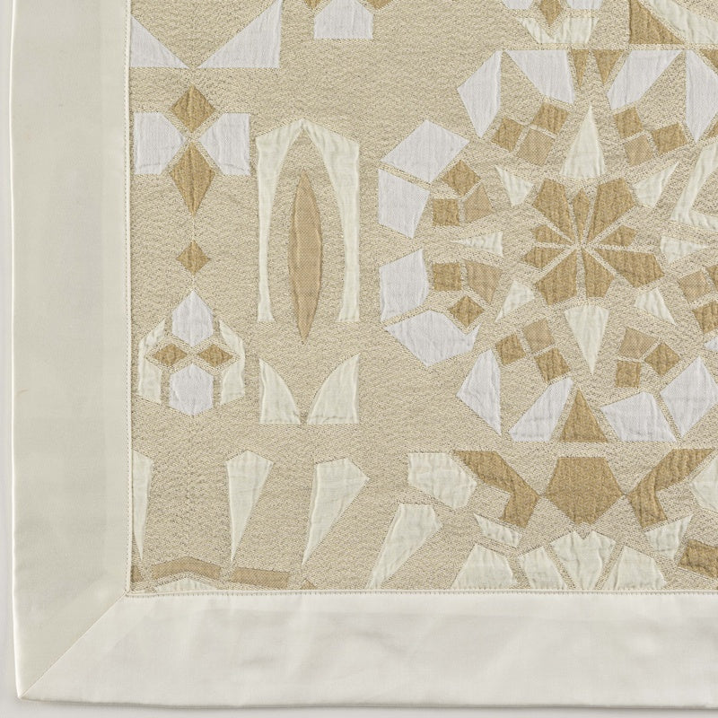 Close-up of a beige and white geometric patterned fabric with a cream border, featuring Milena Cushion Cover by Celso de Lemos available at Linen Society.