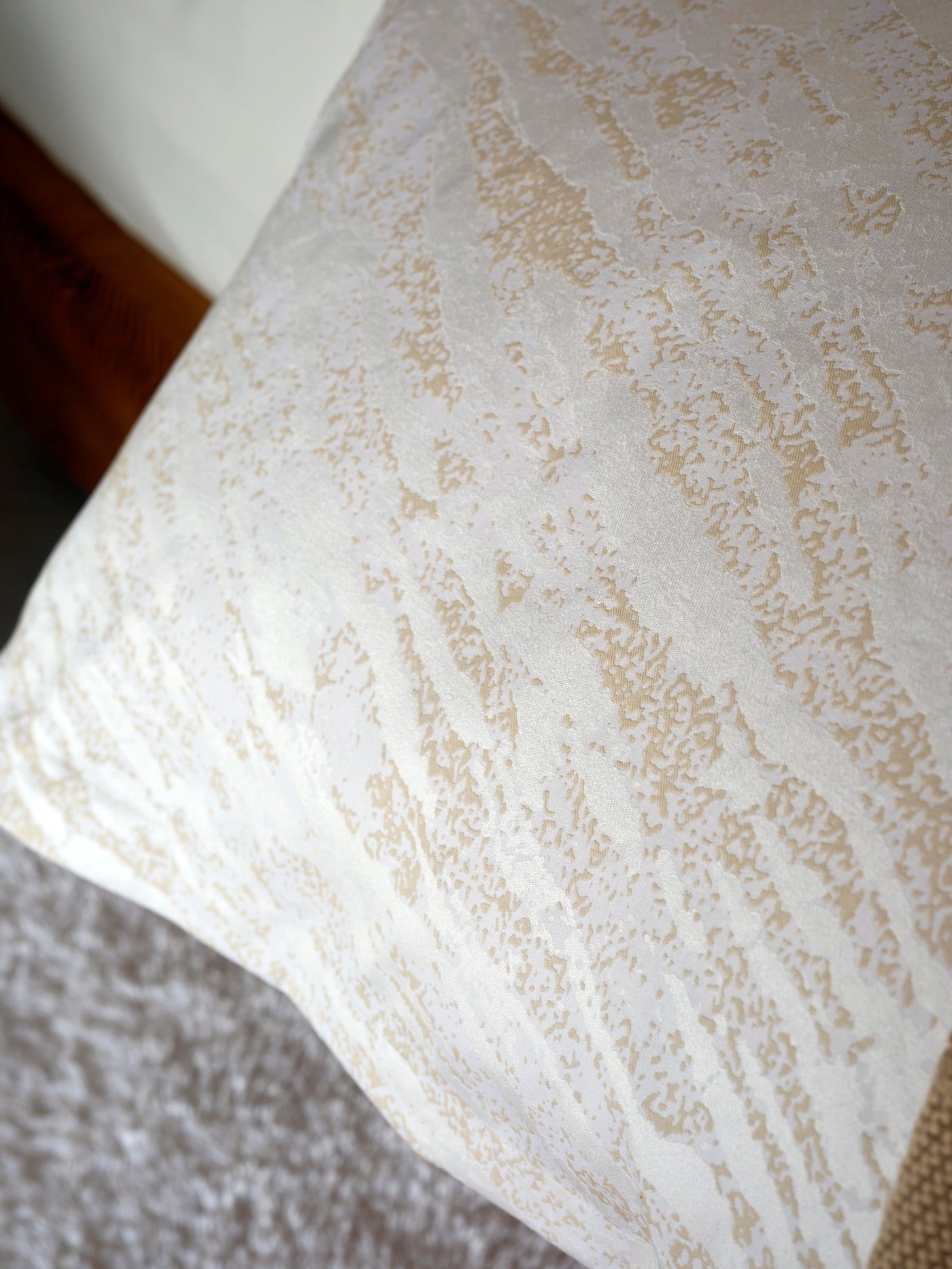 Close-up of ivory Celso de Lemos Neve pillowcase showing champagne textured jacquard weave.