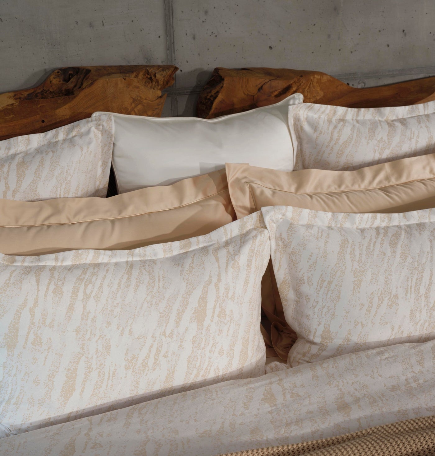 Celso de Lemos Neve ivory and champagne jacquard pillowcase set on styled bed.