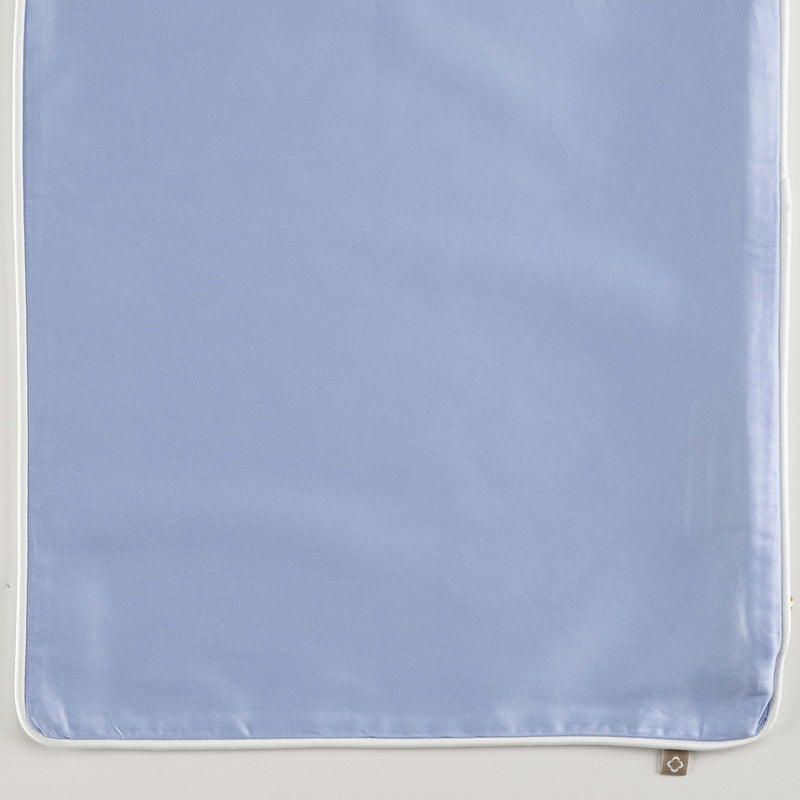 Close-up of a light blue Pillow Cover with white piping, featuring Noa Pillow Cover by Celso de Lemos available at Linen Society.