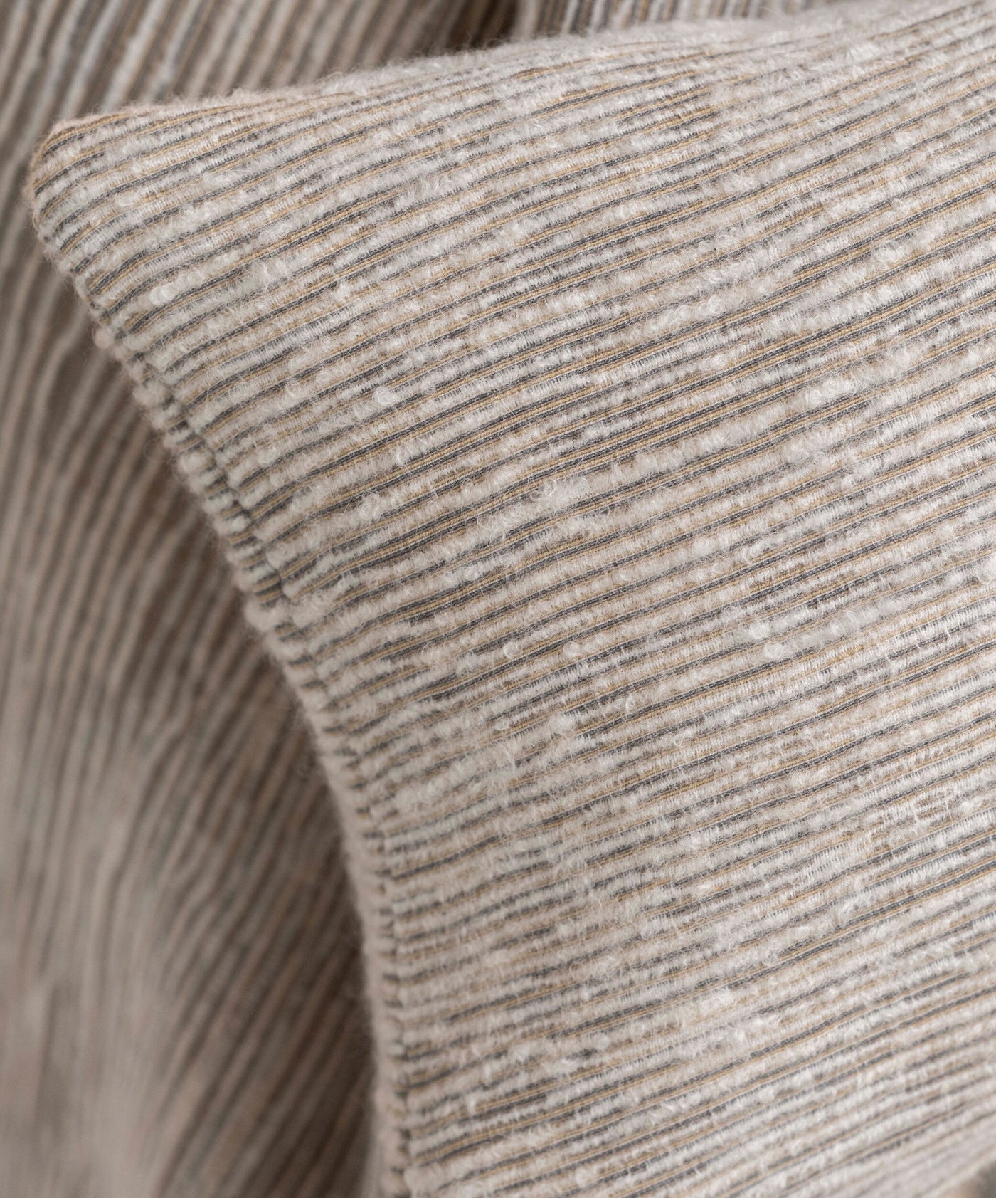 Close-up of a textured pillow with subtle stripes in neutral tones, featuring Panama Pillow Cover by Celso de Lemos available at Linen Society.