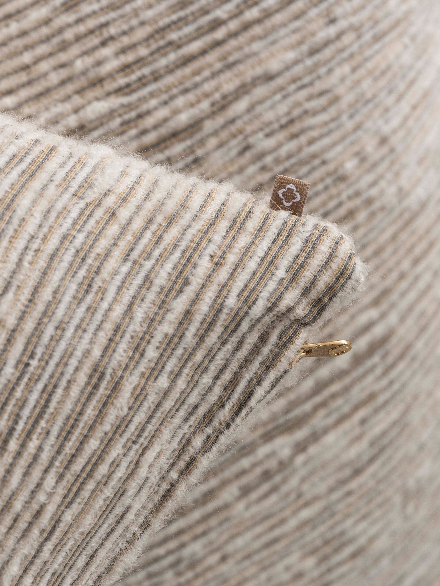 Close-up of a textured stripe fabric in cream, beige, and dark grey, featuring the Panama Pillow Cover by Celso de Lemos available at Linen Society.