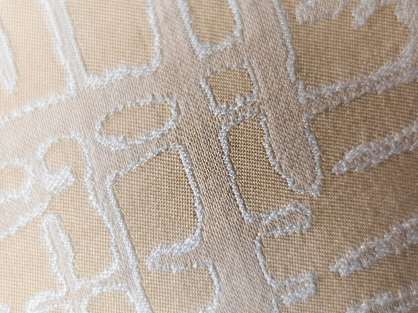 Close-up of Celso de Lemos Partition pillowcase showing ivory geometric jacquard weave detail.
