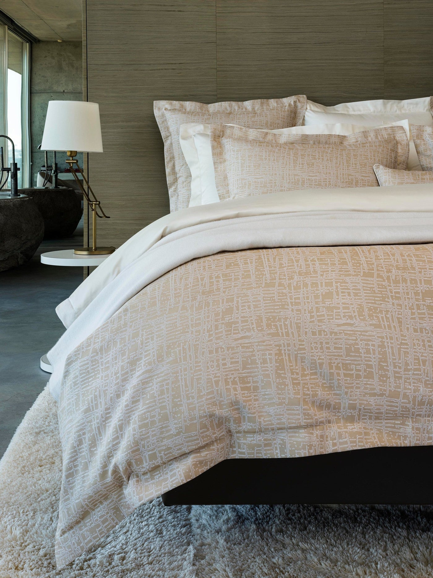 Partition pillowcase styled on bed, showing champagne crosshatch texture against ivory bedding.