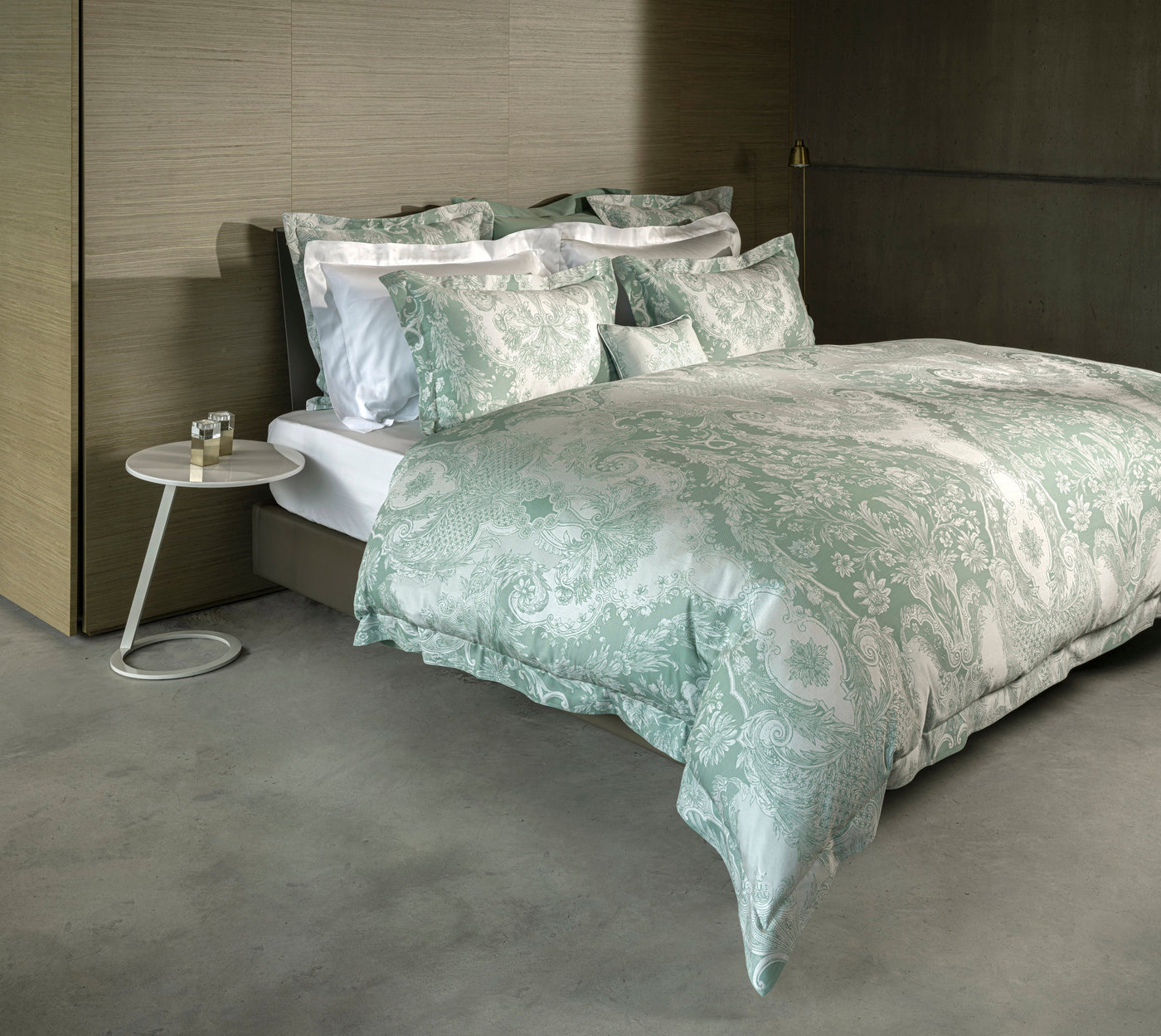 Sage green Pompadour medallion jacquard pillowcase styled on a dressed bed.