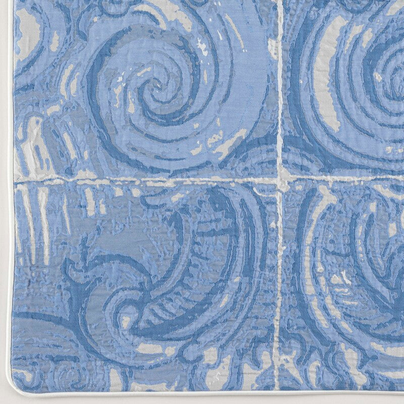 Close-up of Celso de Lemos Porto pillow sham in periwinkle blue with raised swirl tile pattern.