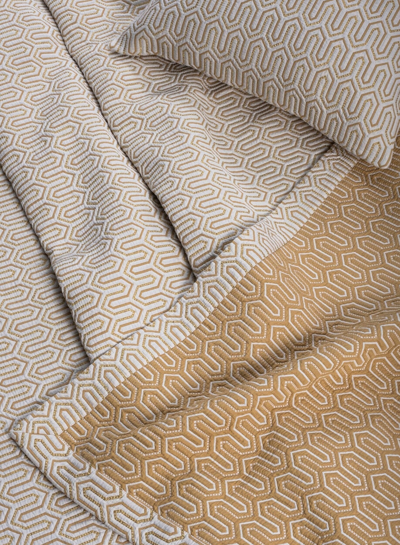 Close-up of Vendome pillow sham in gold and ivory geometric jacquard weave pattern.