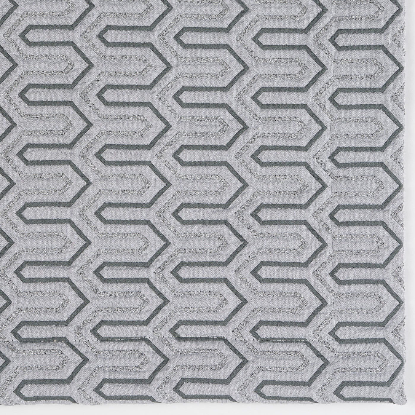 Close-up of Celso de Lemos Vendome pillow cover in silver with woven geometric hexagon pattern.