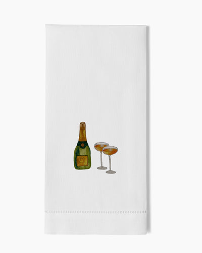 Henry Handwork white linen hand towel with embroidered champagne bottle and two coupe glasses.