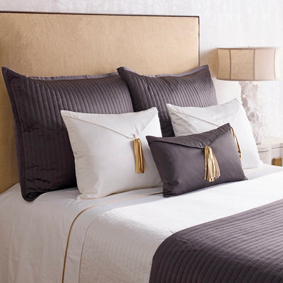 Ann Gish Charmeuse Channel Quilt Coverlet in charcoal and ivory on styled bed.