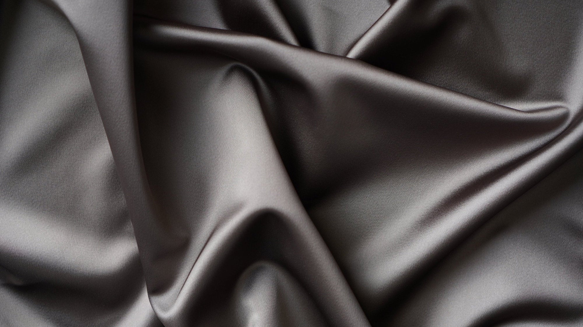 Image of drape detail in a charcoal grey satin fabric