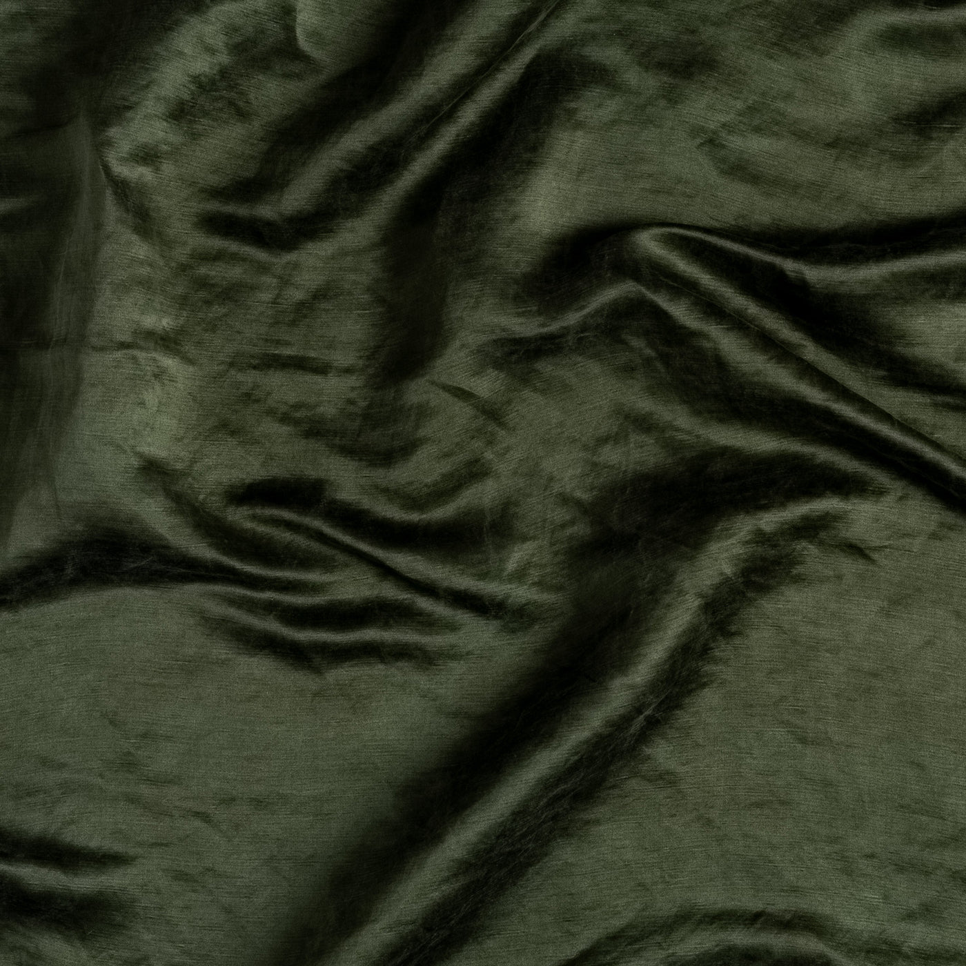 Close-up of Bella Notte Paloma sham in Juniper, showing draped linen fabric texture.