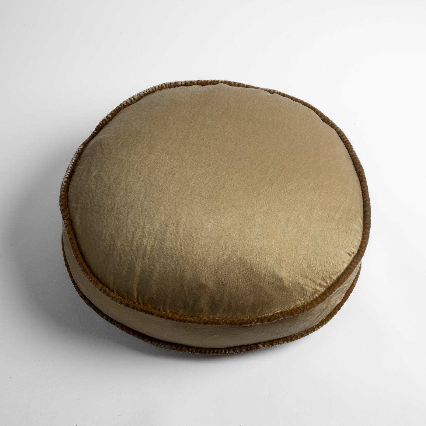 Round Bella Notte Paloma throw pillow in Honeycomb with contrast crochet-edged trim, side angle view.