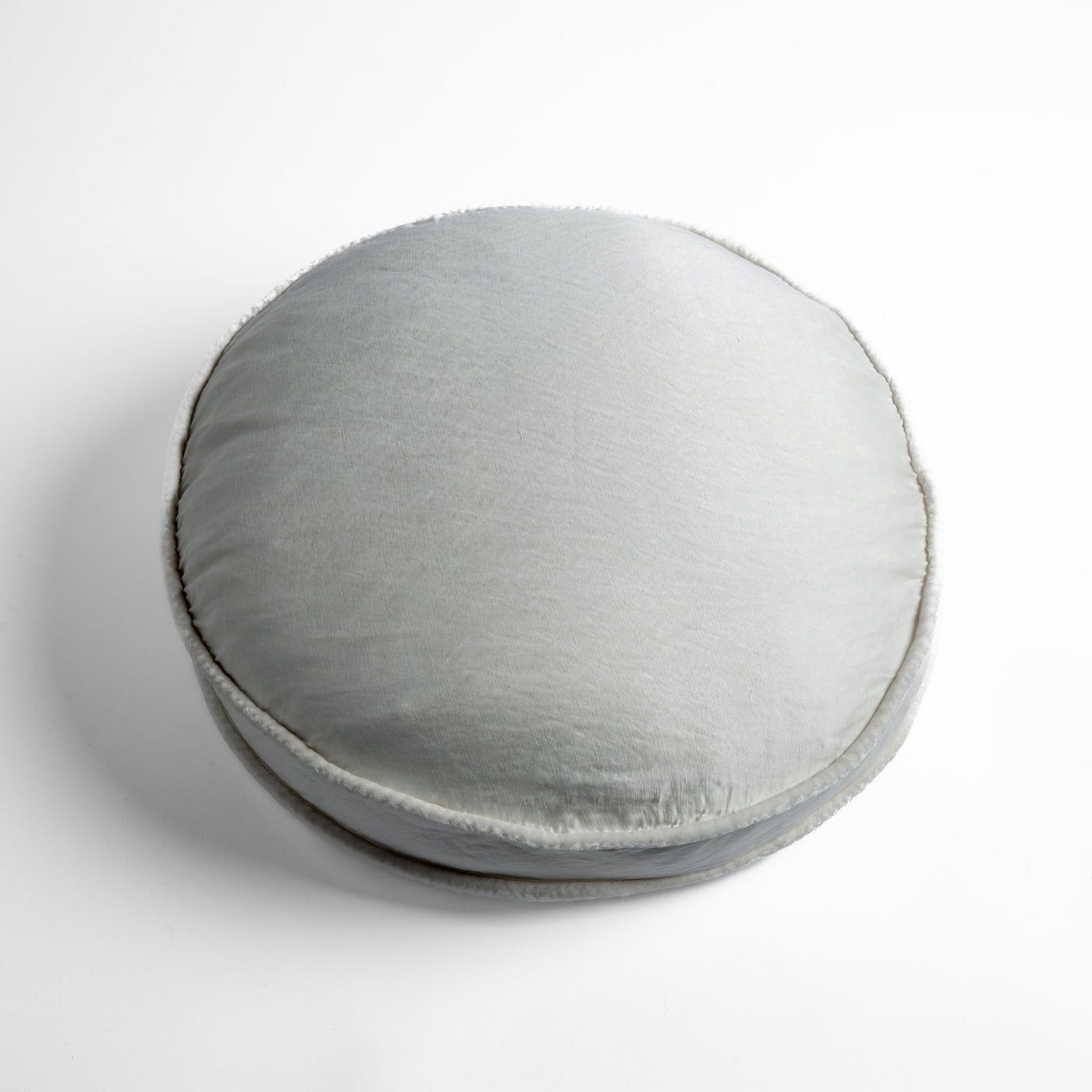 Bella Notte Paloma round throw pillow in Winter White, plush velvet with contrast trim.