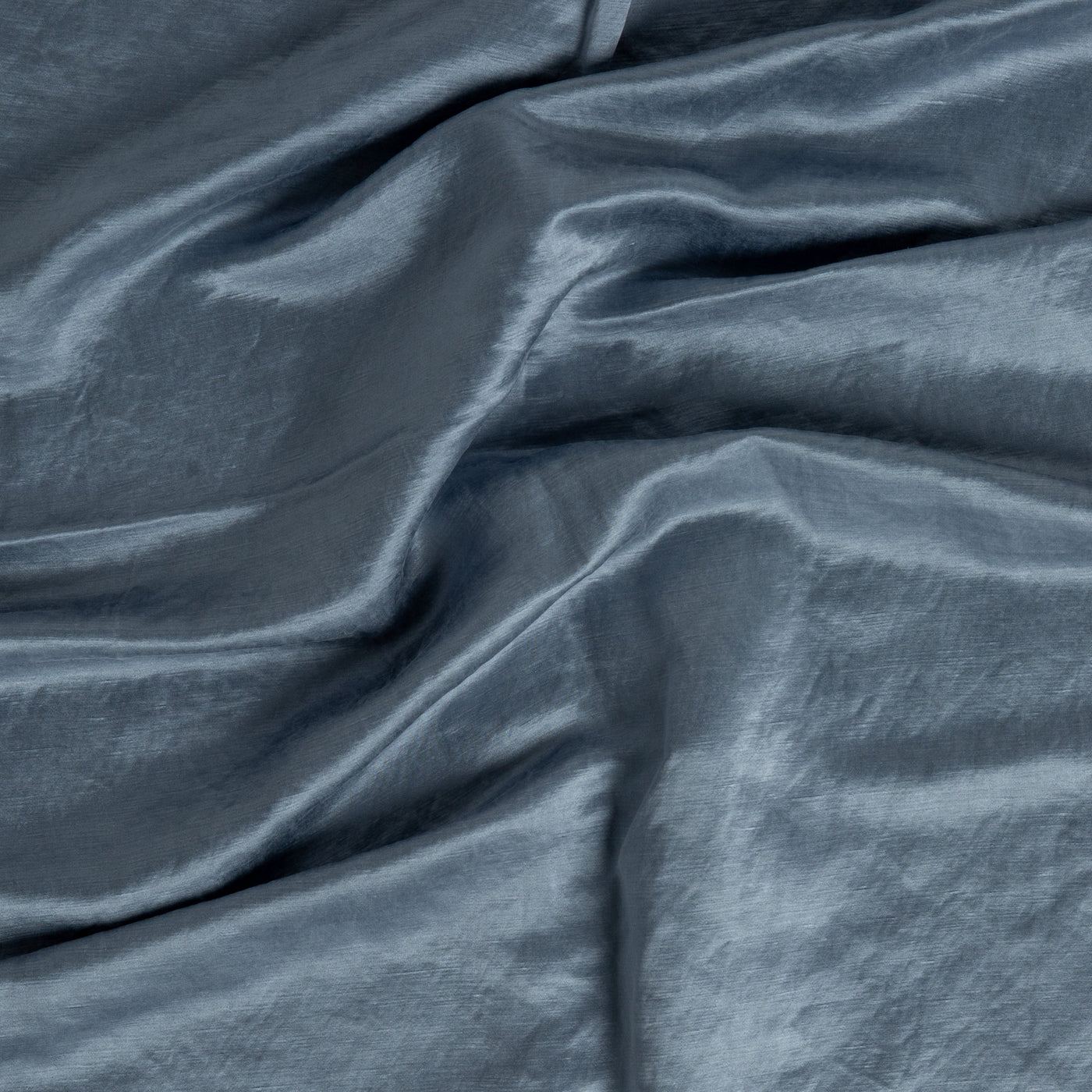 Close-up of Bella Notte Paloma duvet cover in Tahoe Blue, showing silky draped fabric texture.