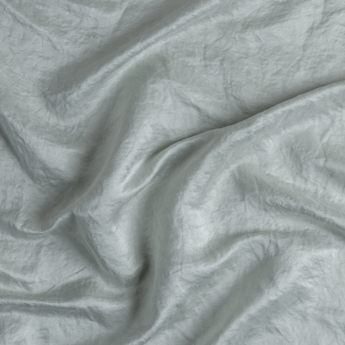 Close-up of draped Cloud Bella Notte Paloma linen fabric showing soft creased texture.